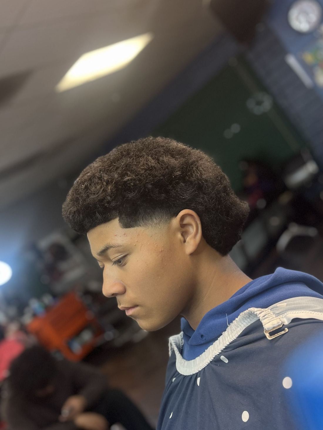 Taper fade from behind, blended to the skin